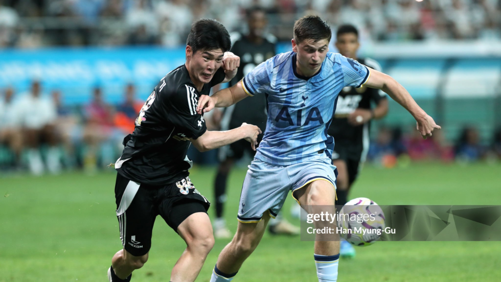 Mikey Moore maintains control of the ball while under pressure from Team K League's Hwang Mun-ki during a pre-season friendly.